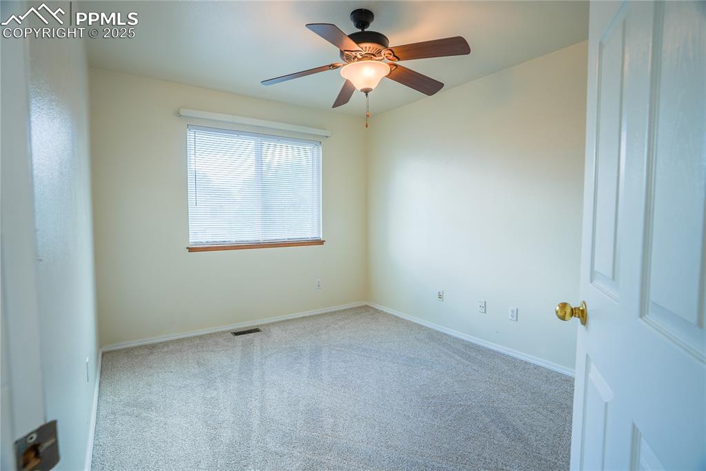 Image 9 of 37: Carpeted spare room with baseboards and ceiling fan