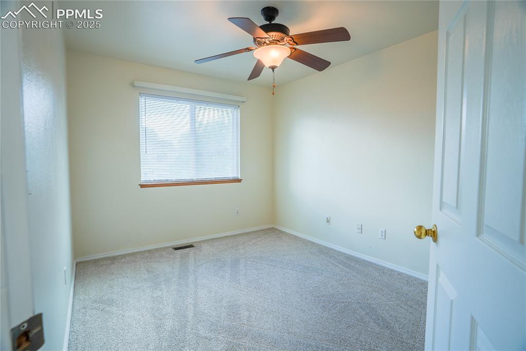 Image 9 of 37: Carpeted spare room with baseboards and ceiling fan