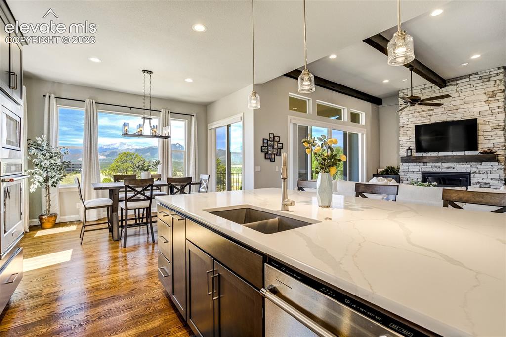 Image 12 of 50: The heart of the home features a substantial granite island, quartz perimet