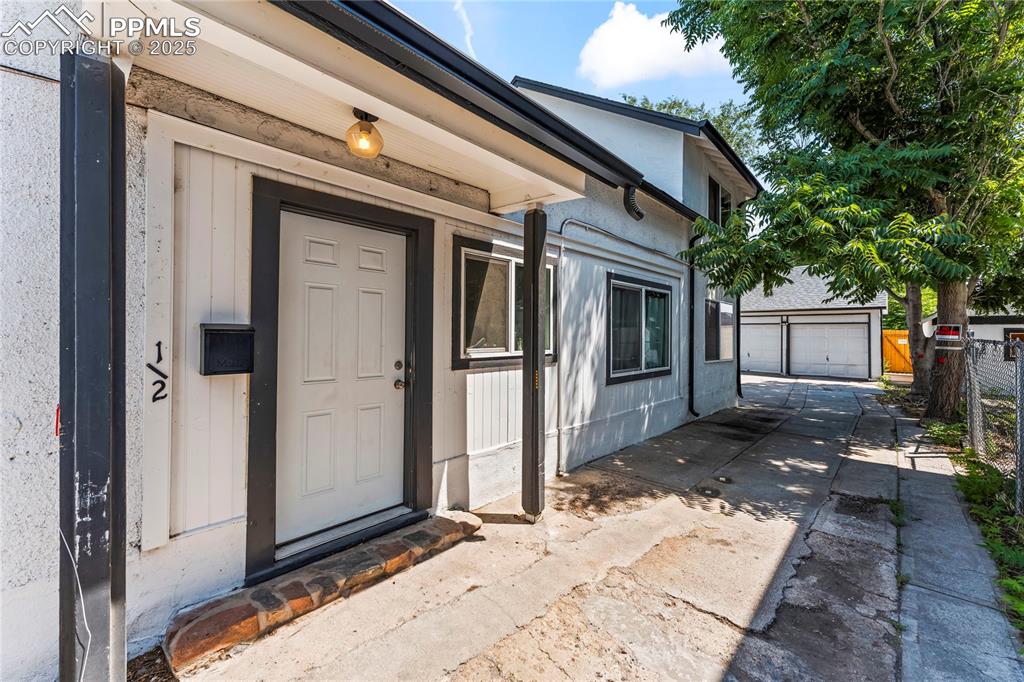 Image 4 of 19: View of exterior entry with a garage