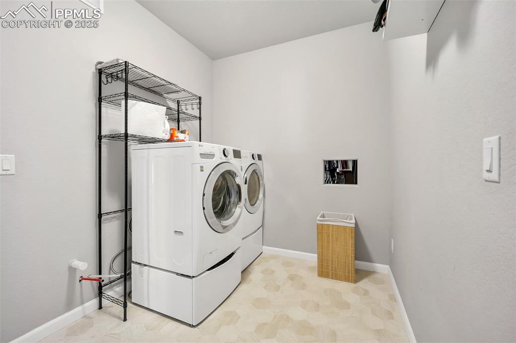 Image 20 of 45: Mudroom featuring laundry area with convenient laundry chute from the prima