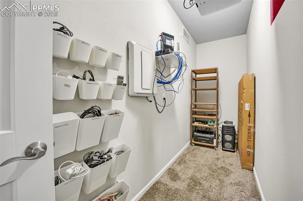 Image 28 of 45: Dedicated A/V closet for theatre projector and peripherals