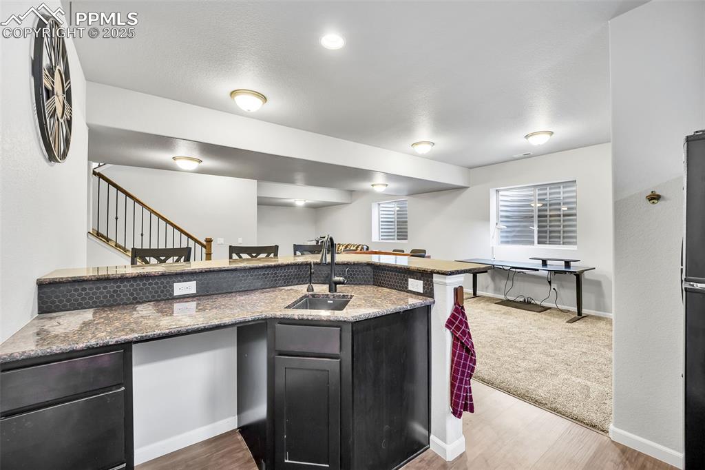 Image 29 of 45: Full wet bar with space for a full-size fridge and ice maker connection