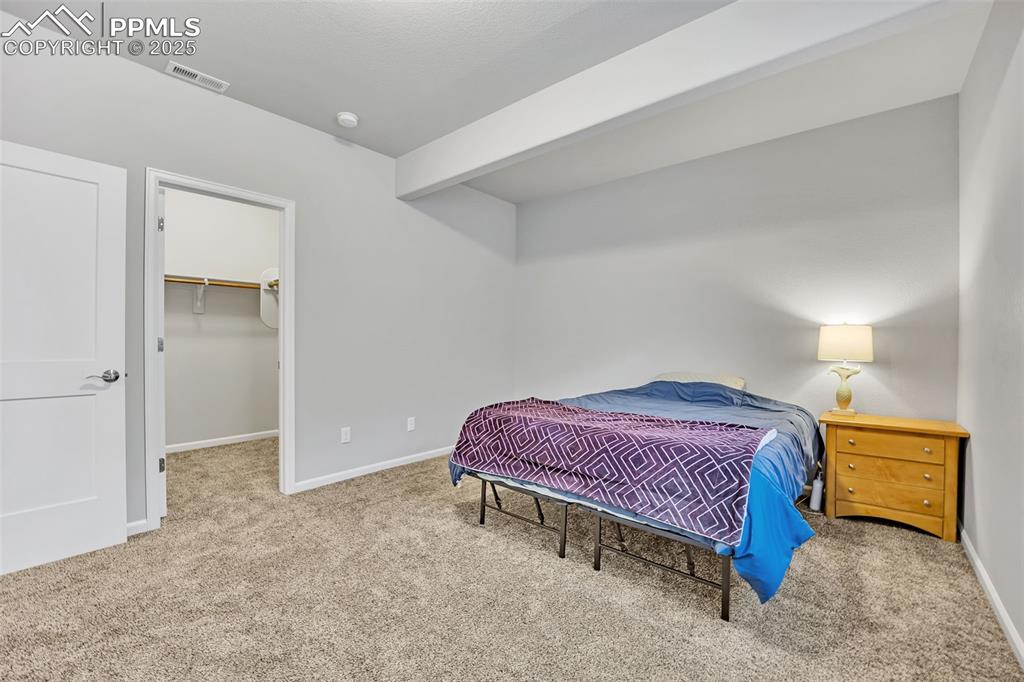 Image 33 of 45: Second bedroom with a walk-in closet