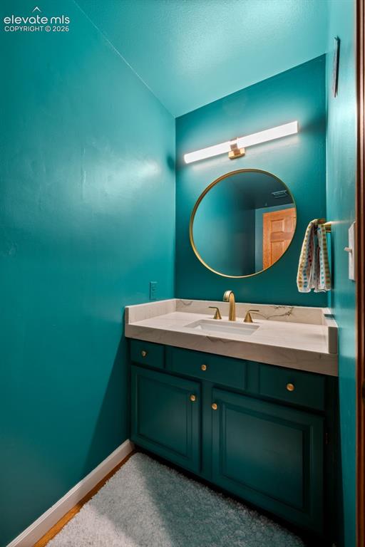 Image 19 of 47: Vanity with integrated sink and stone countertop