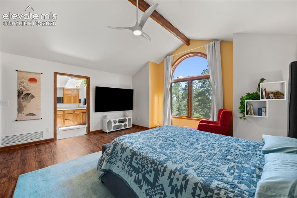 Image 21 of 47: Vaulted ceiling with exposed wood beam and contemporary ceiling fan