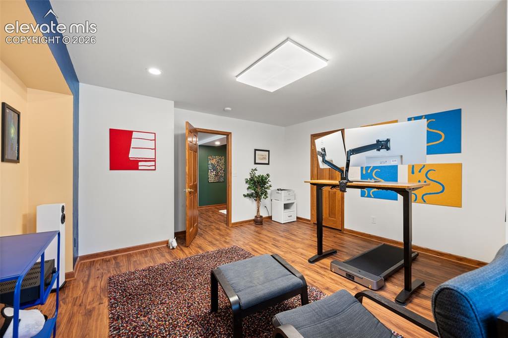 Image 25 of 47: Interior room featuring wood-finish flooring, recessed lighting, a rectangu
