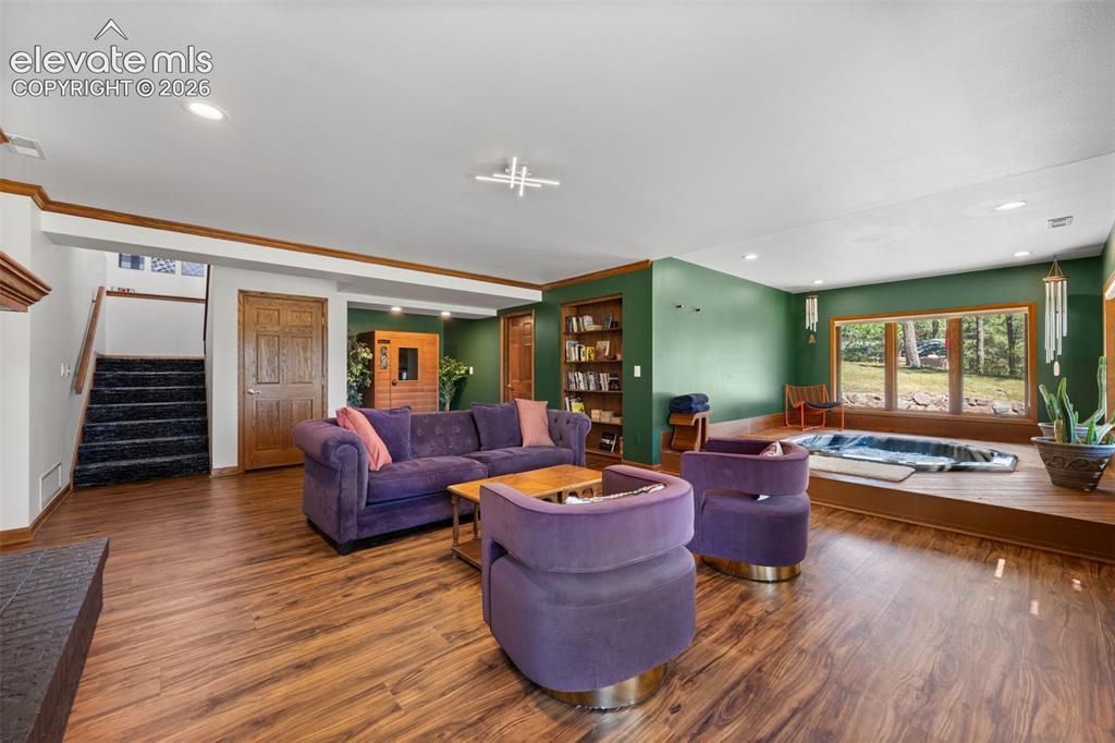 Image 33 of 47: Spacious lower-level area featuring wood-finish flooring, recessed lighting