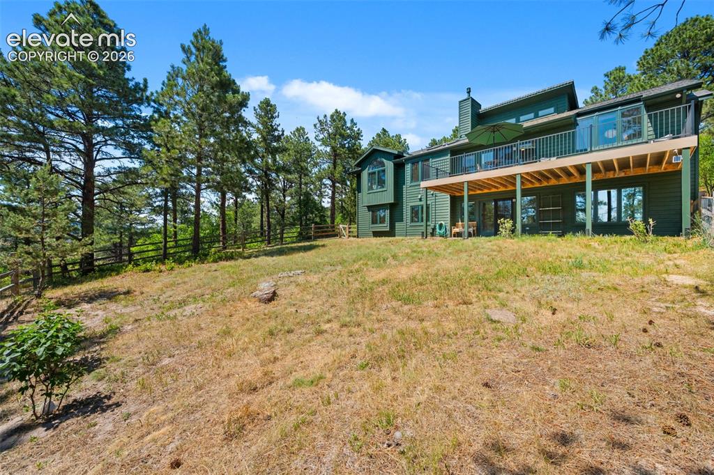 Image 36 of 47: Contemporary multi-level residence featuring a large elevated deck with gla