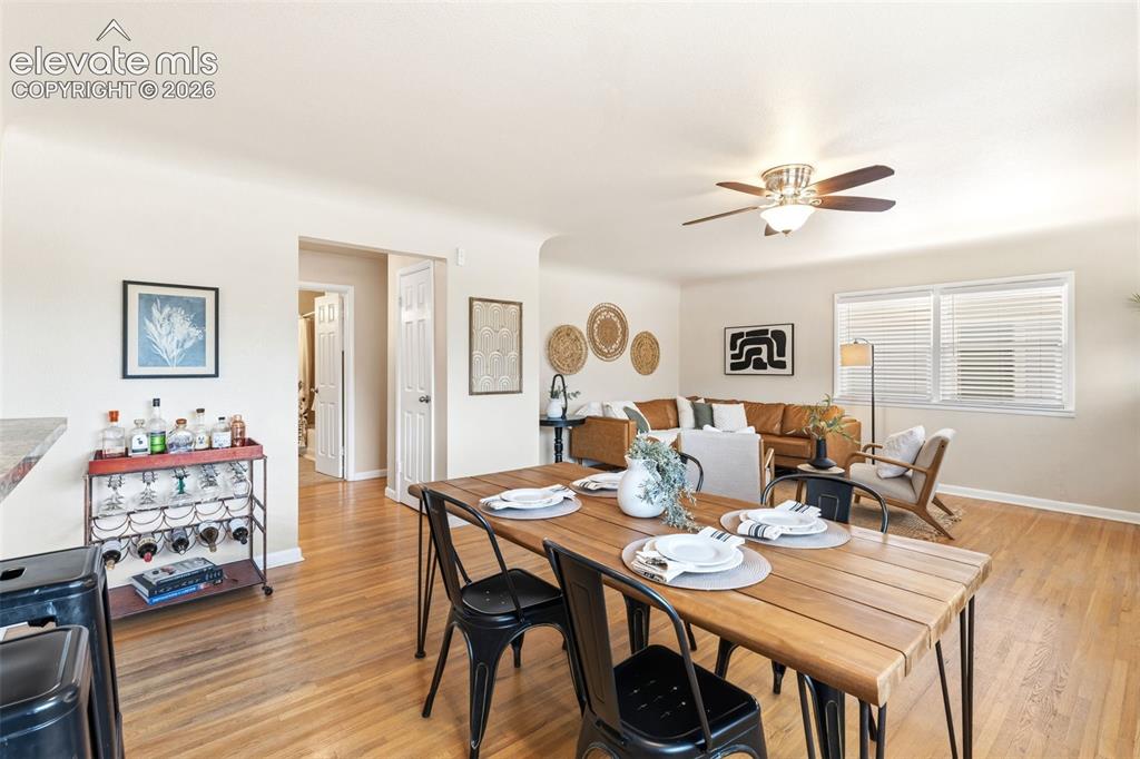 Image 16 of 48: Open-concept living area featuring wood-finish flooring, a contemporary cei