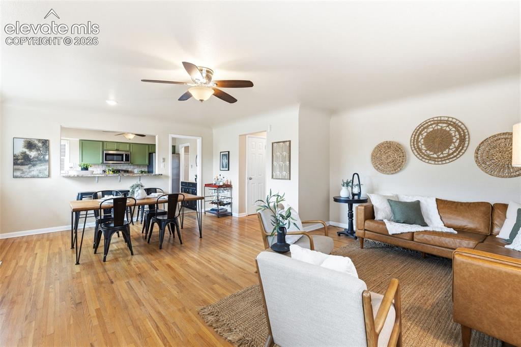 Image 17 of 47: Hardwood flooring extending throughout the living and dining areas