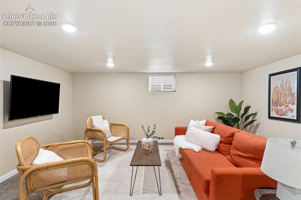 Image 31 of 47: Recessed ceiling lighting illuminates this versatile room with carpet floor