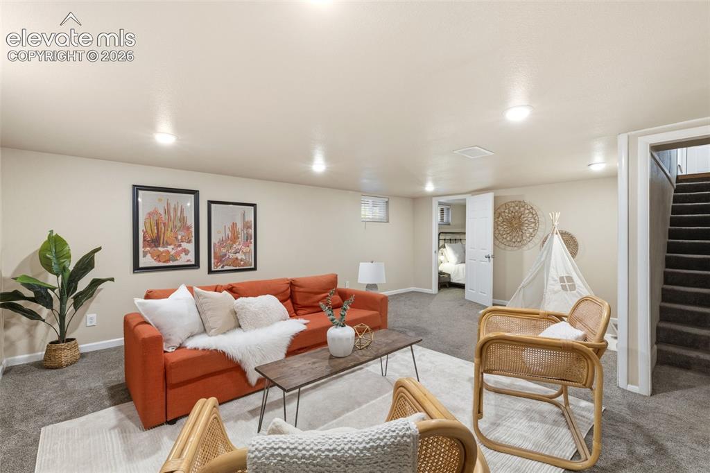 Image 32 of 47: Finished basement living area featuring neutral-toned walls, recessed light