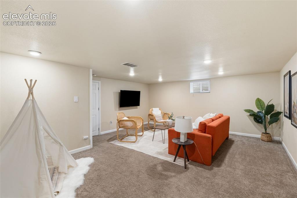 Image 34 of 47: Spacious room featuring neutral carpeting, recessed lighting, and a window
