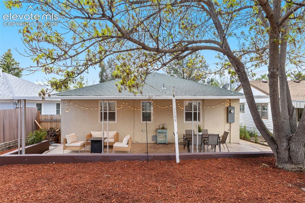 Image 40 of 47: Rear exterior featuring a stucco finish, a covered patio, and a concrete pa