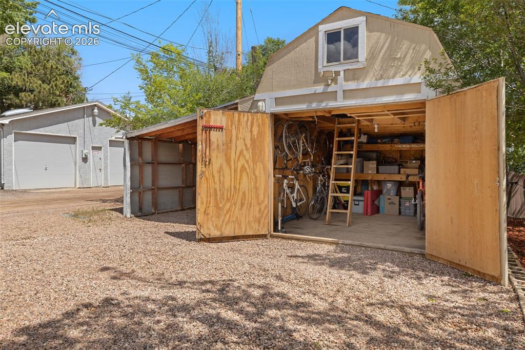 Image 43 of 47: Detached storage shed with barn-style roofline and upper-level window