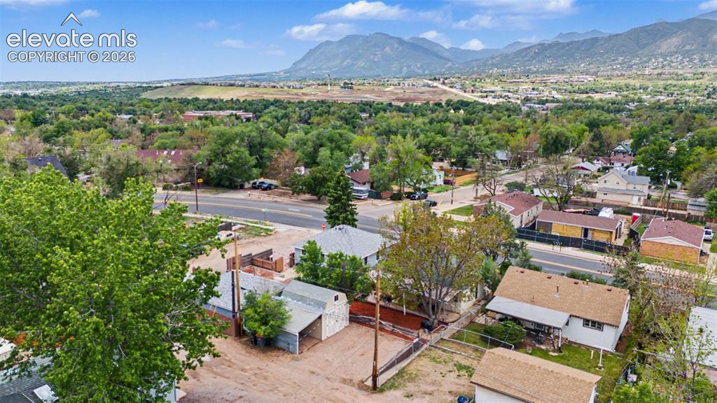 Image 47 of 47: Expansive aerial perspective showcasing a residential area with mature tree