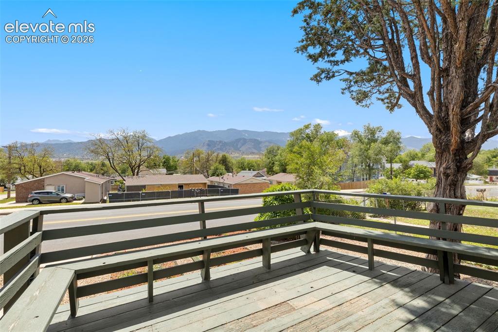 Image 5 of 47: Spacious wooden deck featuring integrated bench seating and a sturdy wooden