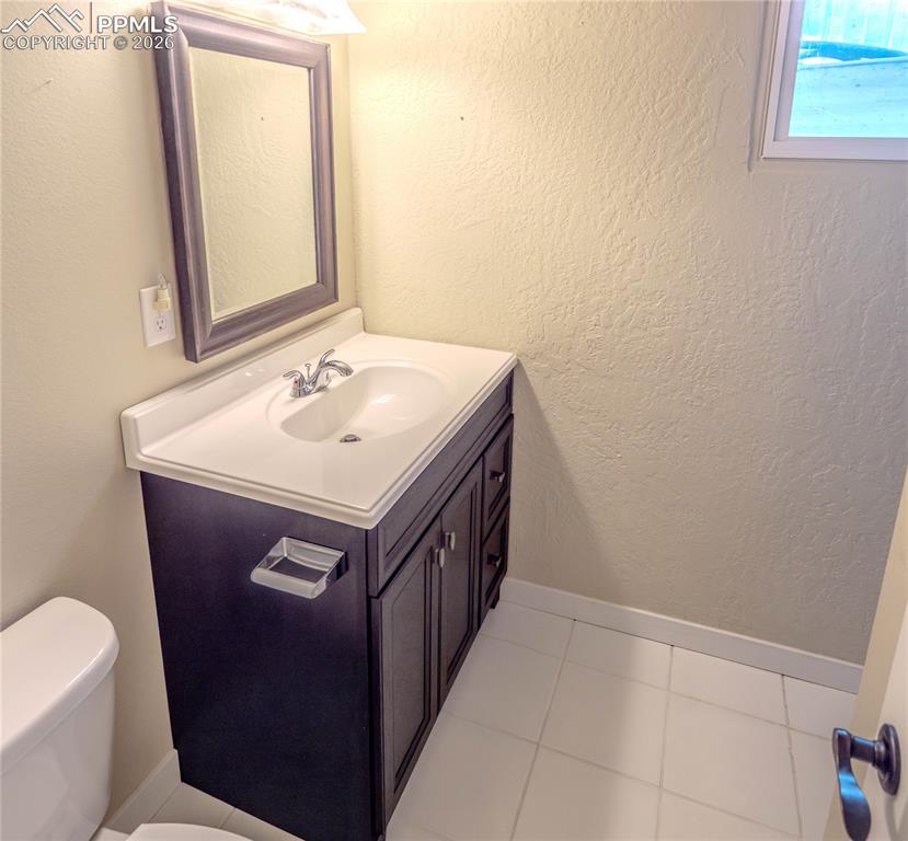 Image 17 of 29: Carpeted interior space featuring neutral wall paint, white trim, and a dro
