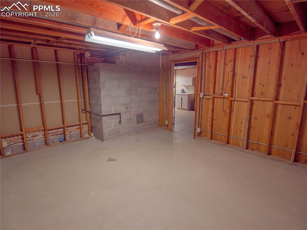 Image 20 of 29: Expansive utility space featuring concrete flooring, exposed ceiling joists