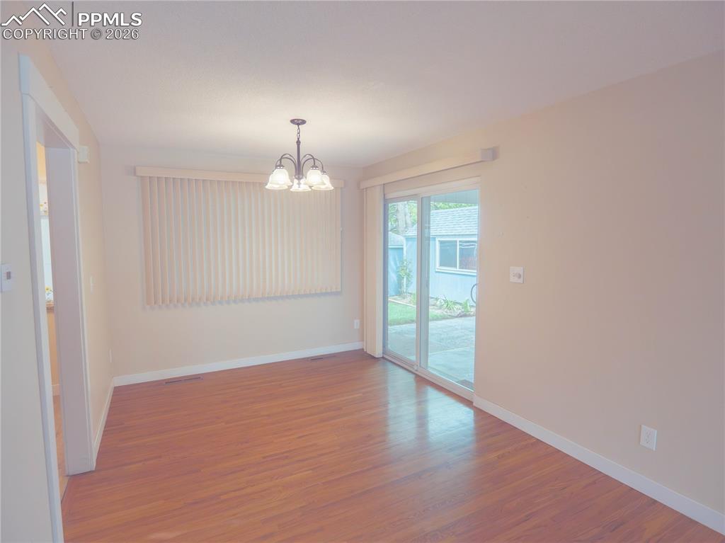 Image 7 of 29: Living Room Hardwood flooring spanning a spacious interior with neutral wal