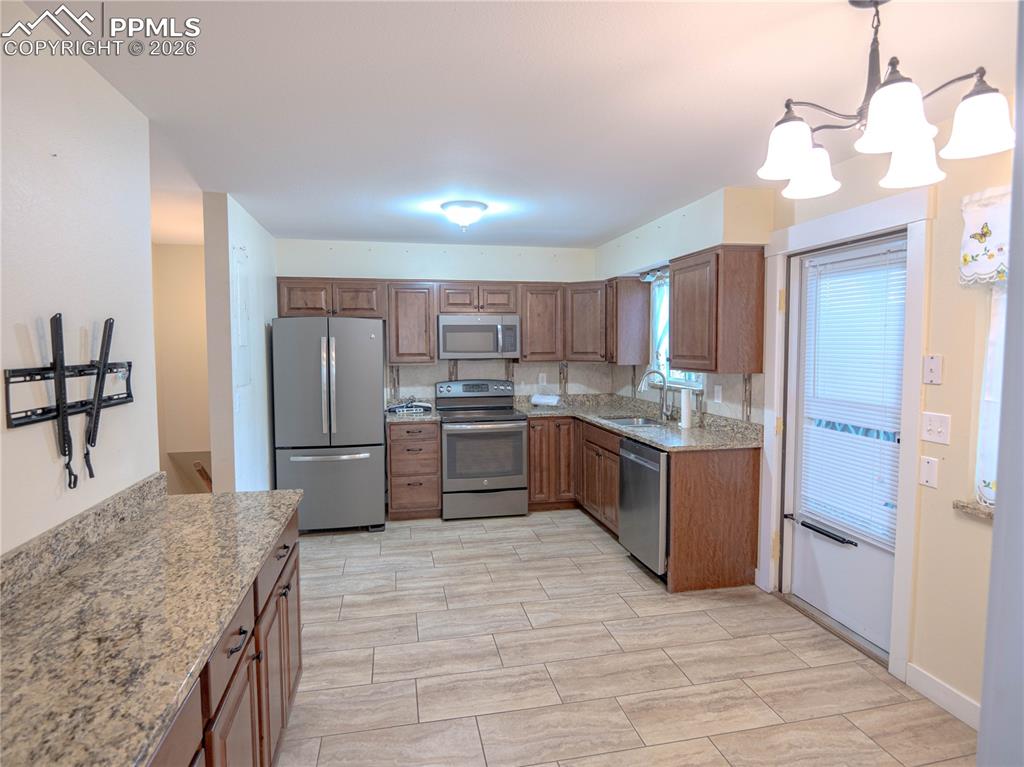 Image 8 of 29: Spacious open-concept room featuring wood-finish flooring, a fireplace with