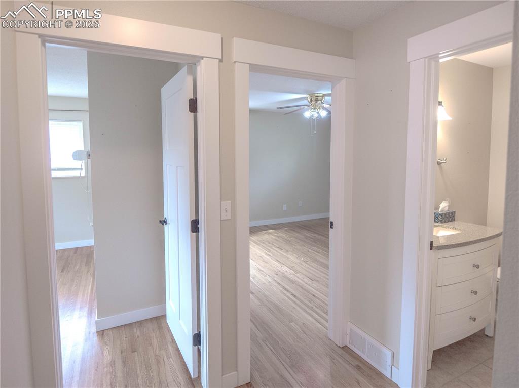 Image 9 of 29: Hardwood flooring throughout, featuring a multi-light chandelier, vertical 