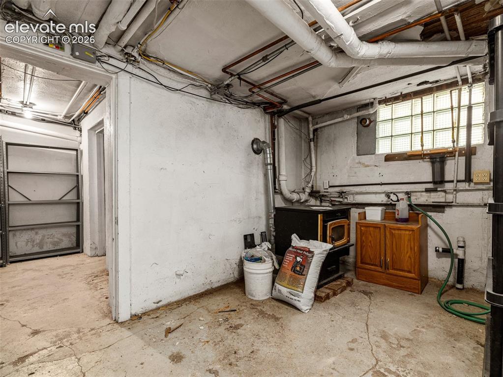 Image 36 of 49: Pellet Stove in basement stays