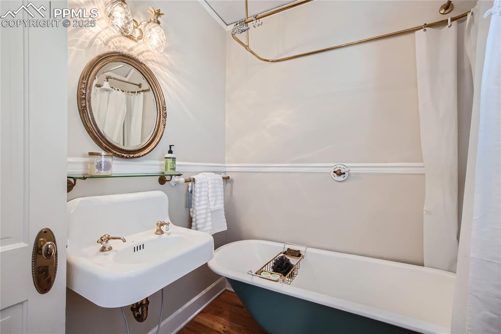 Image 37 of 49: Bathroom featuring sink and hardwood floors