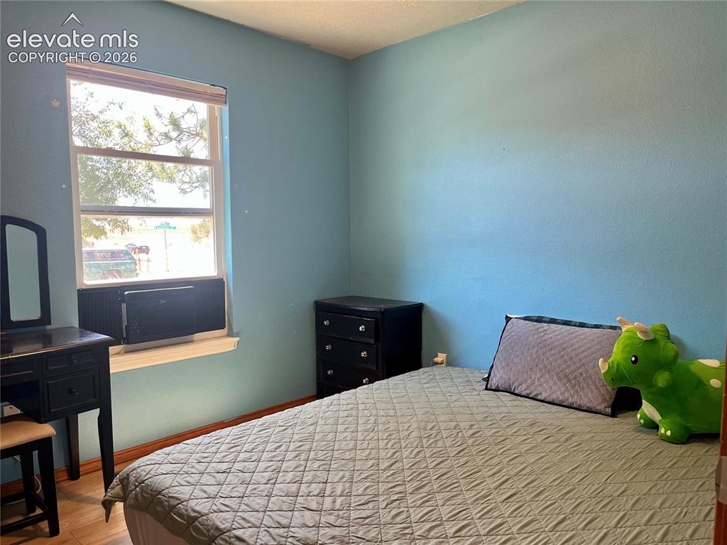 Image 10 of 21: bedroom with laminate flooring