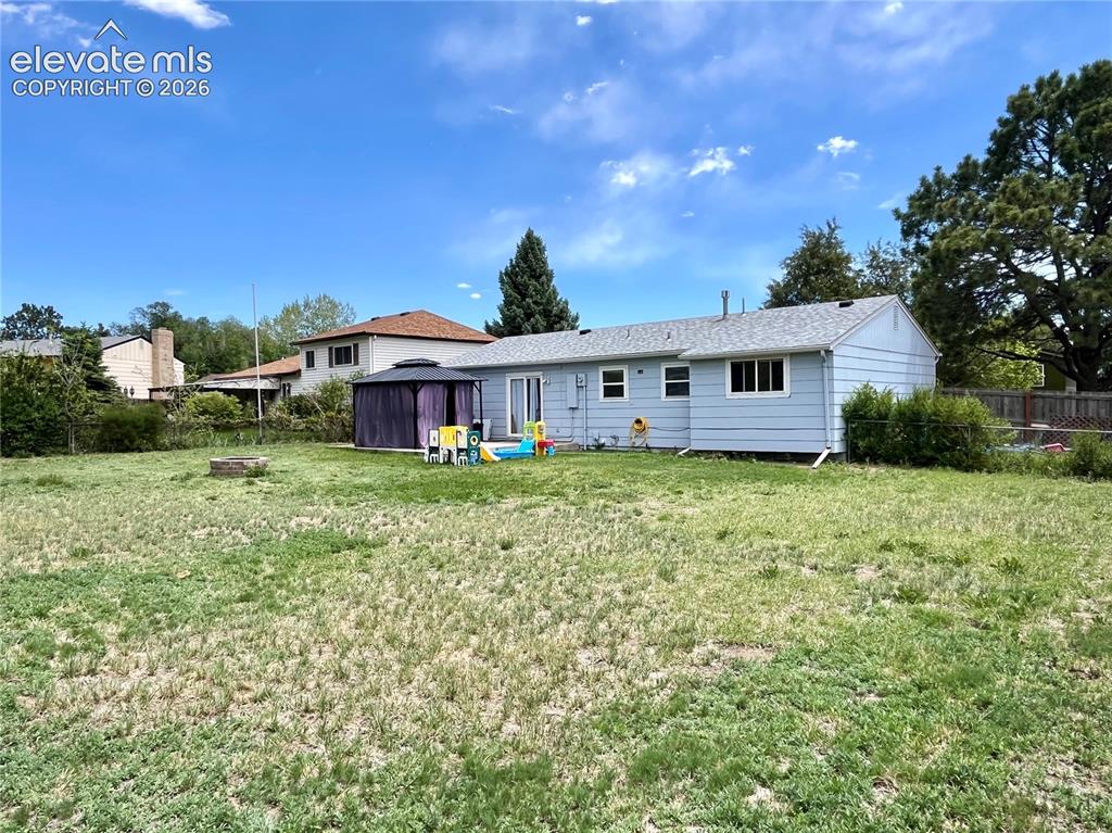 Image 20 of 21: Large fenced backyard with storage shed included