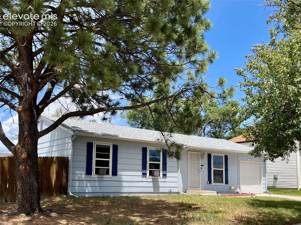 Image 21 of 21: Corner lot setting with mature trees and mountain views