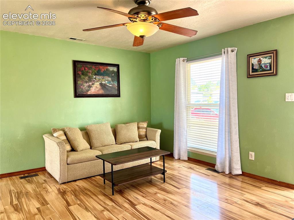 Image 7 of 21: Bright living room with laminate wood flooring