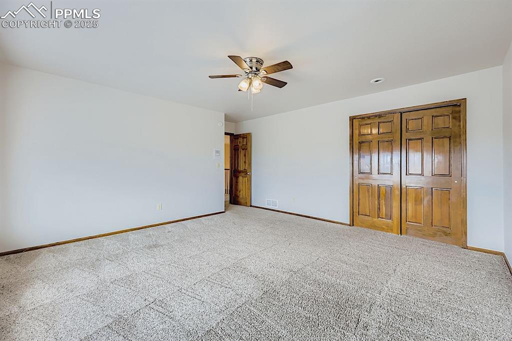 Image 31 of 48: Unfurnished bedroom with a closet, carpet flooring, a ceiling fan, and rece