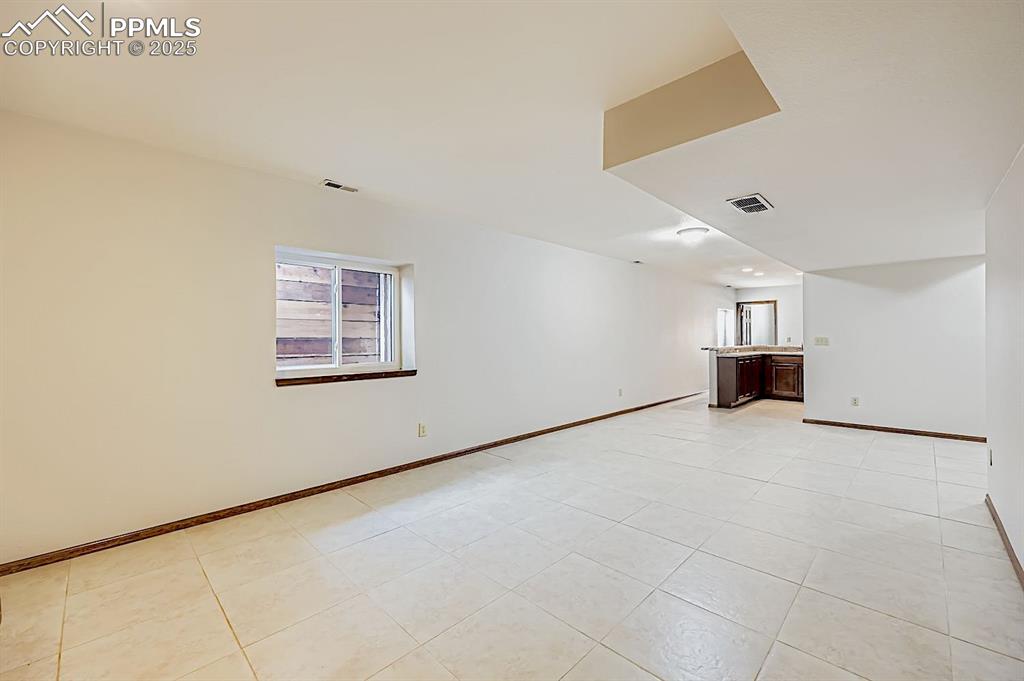 Image 36 of 48: Unfurnished living room with light tile patterned floors