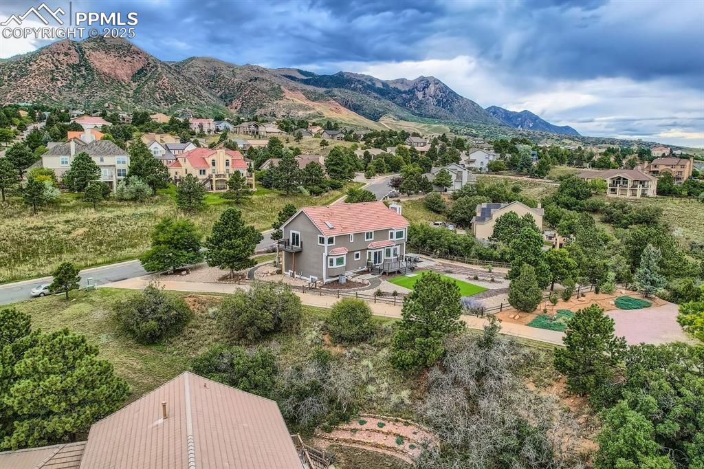 Image 44 of 48: Aerial view of residential area featuring mountains