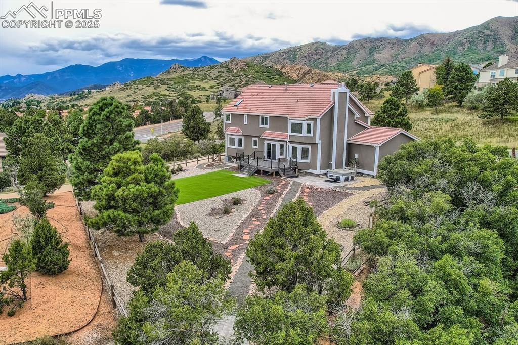 Image 46 of 48: Aerial view of property and surrounding area featuring mountains