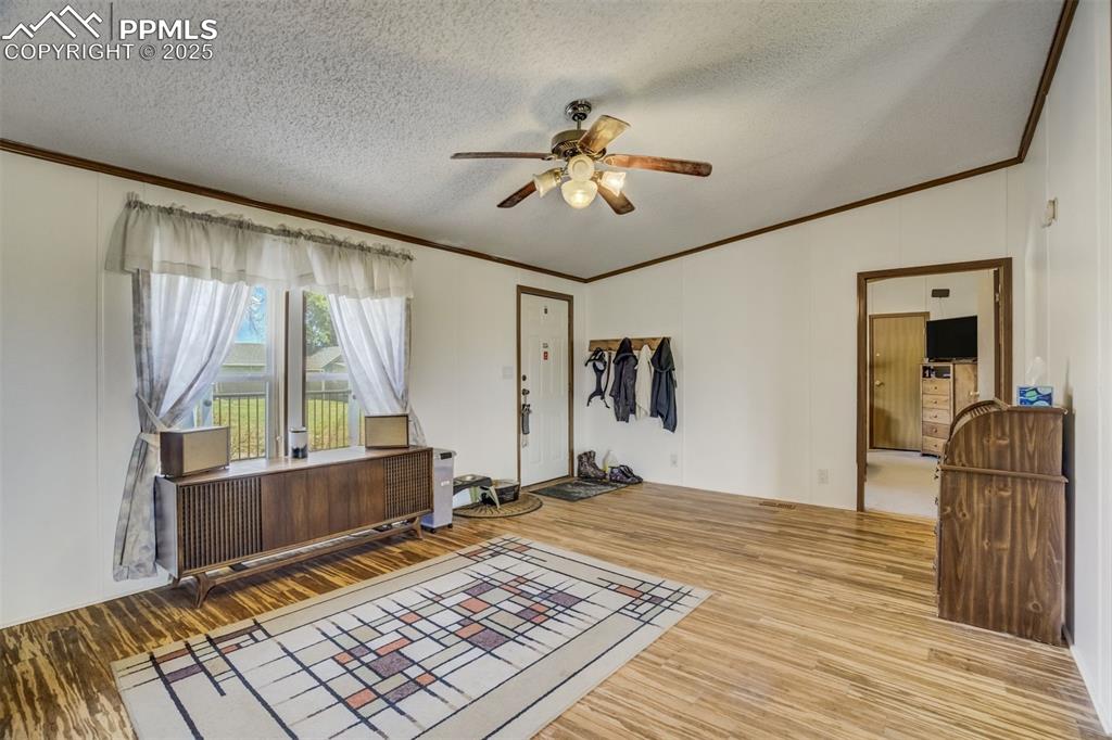 Image 10 of 50: Unfurnished room featuring ornamental molding, wood finished floors, vaulte