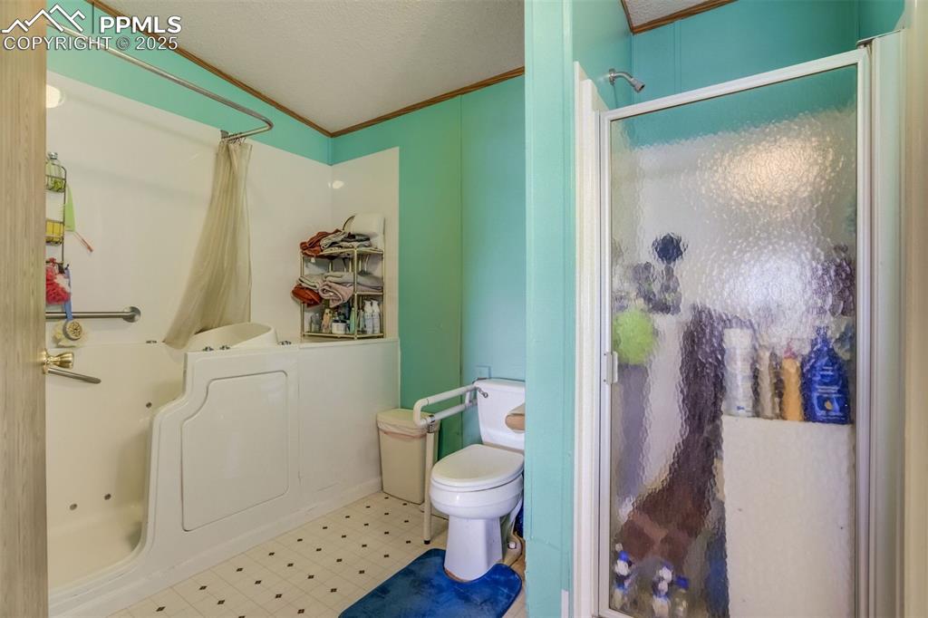 Image 19 of 50: Full bath featuring tile patterned floors and crown molding
