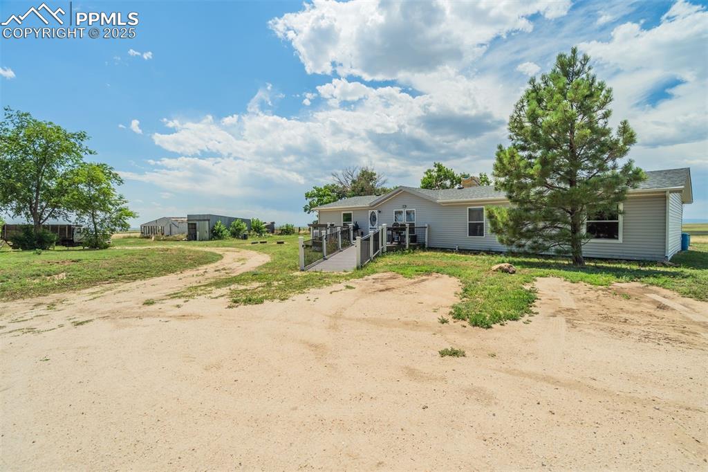 Image 3 of 50: View of front of property with dirt driveway