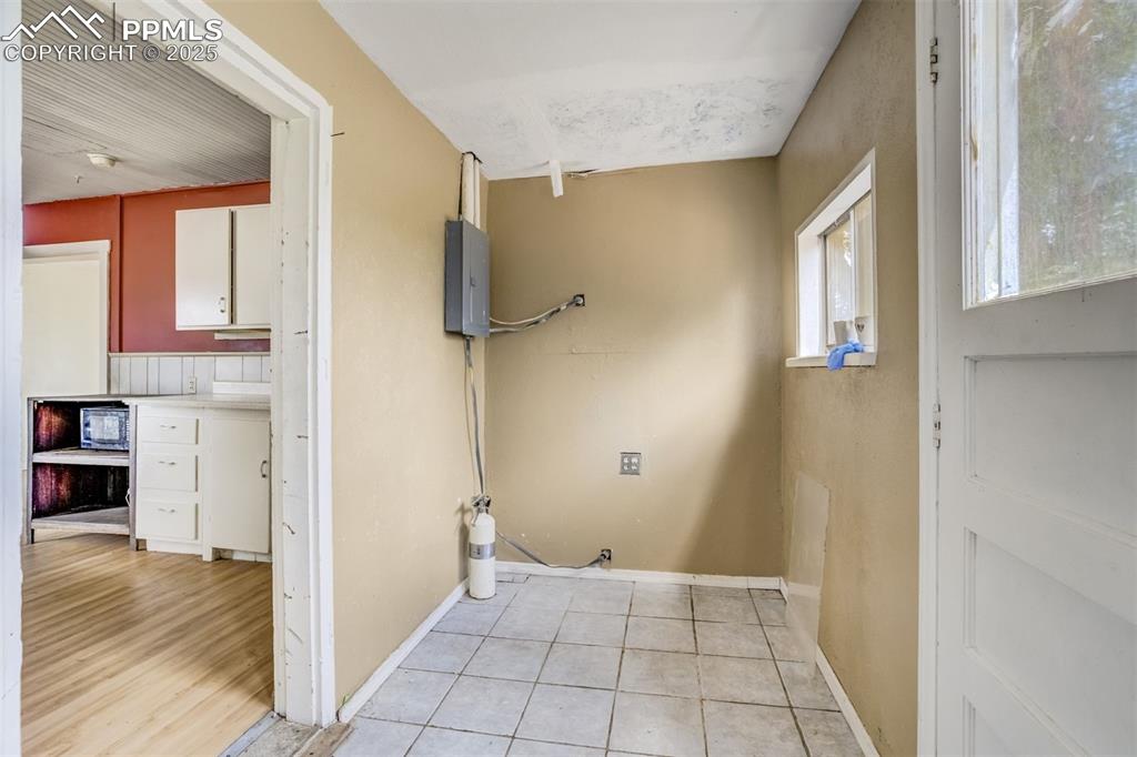 Image 38 of 50: Washroom featuring electric panel and light tile patterned flooring
