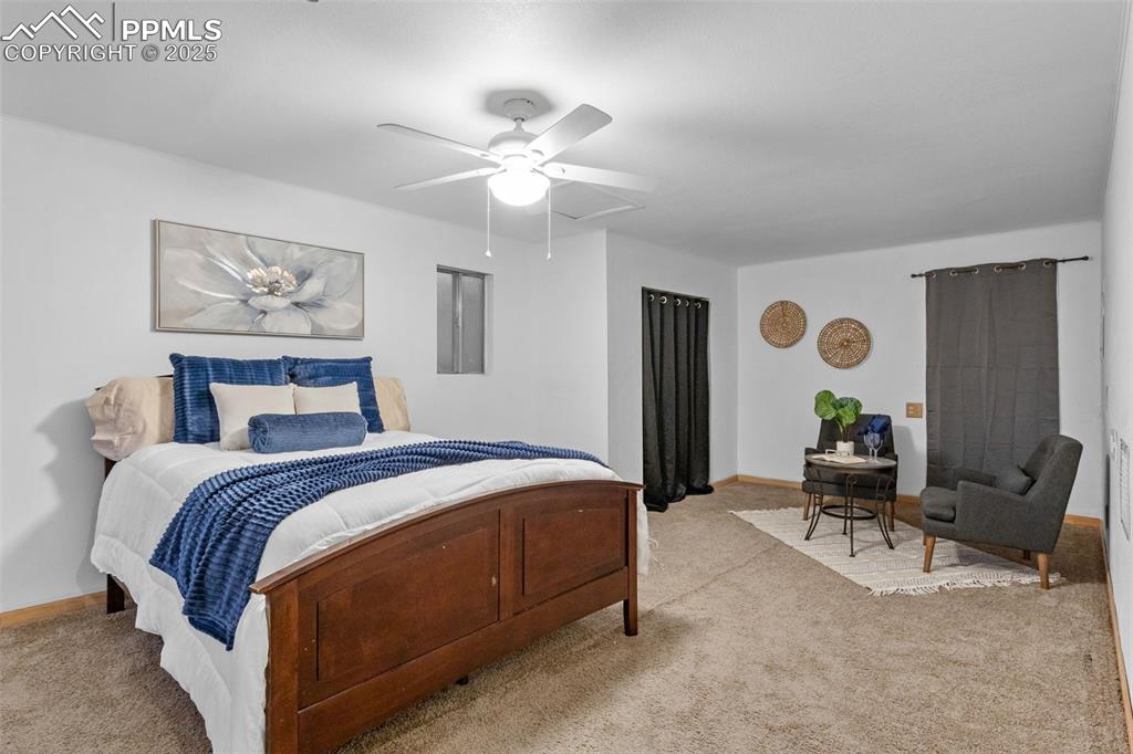 Image 11 of 28: Large primary bedroom with seating area and walkout to back yard.