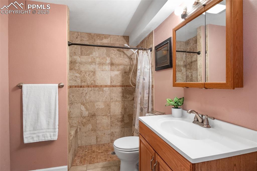 Image 22 of 28: Updated full stand up shower with built in seating