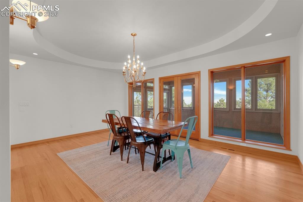 Image 18 of 48: Formal dining area - walk out to sunroom, tray ceiling