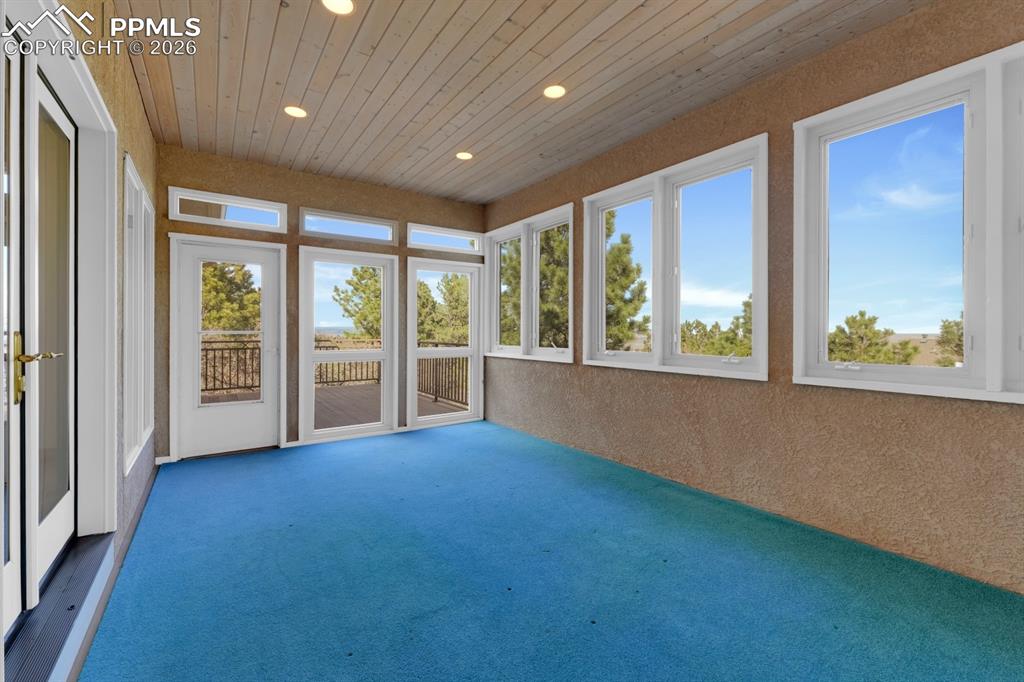 Image 20 of 48: Sunroom featuring wooden ceiling & views