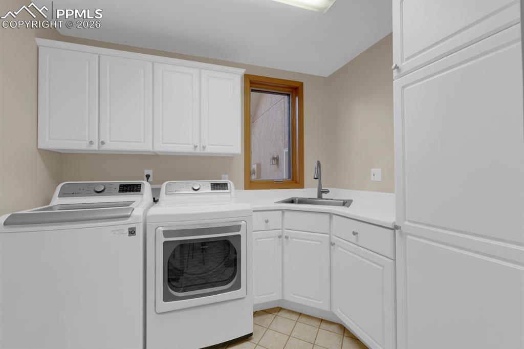 Image 25 of 48: Laundry room - main level with sink, window and cabinets