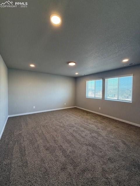 Image 11 of 11: Unfurnished room with carpet floors, a textured ceiling, and recessed light