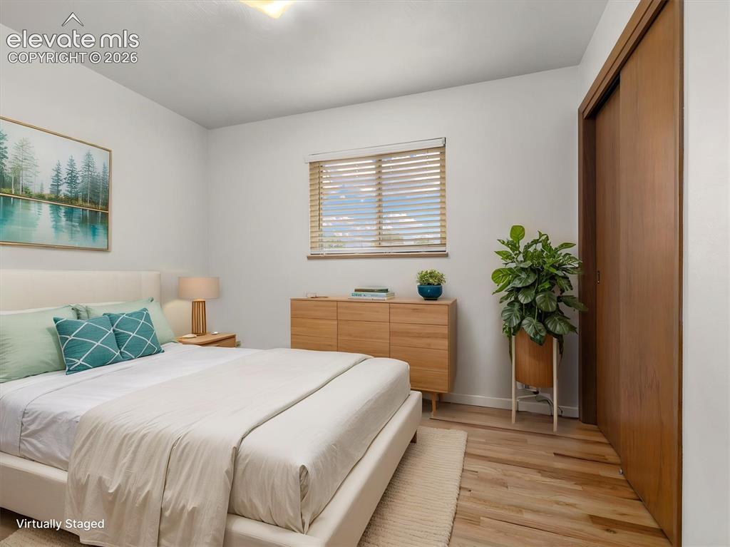 Image 19 of 34: Hardwood flooring, wood-finish window blinds, and a built-in closet with sl