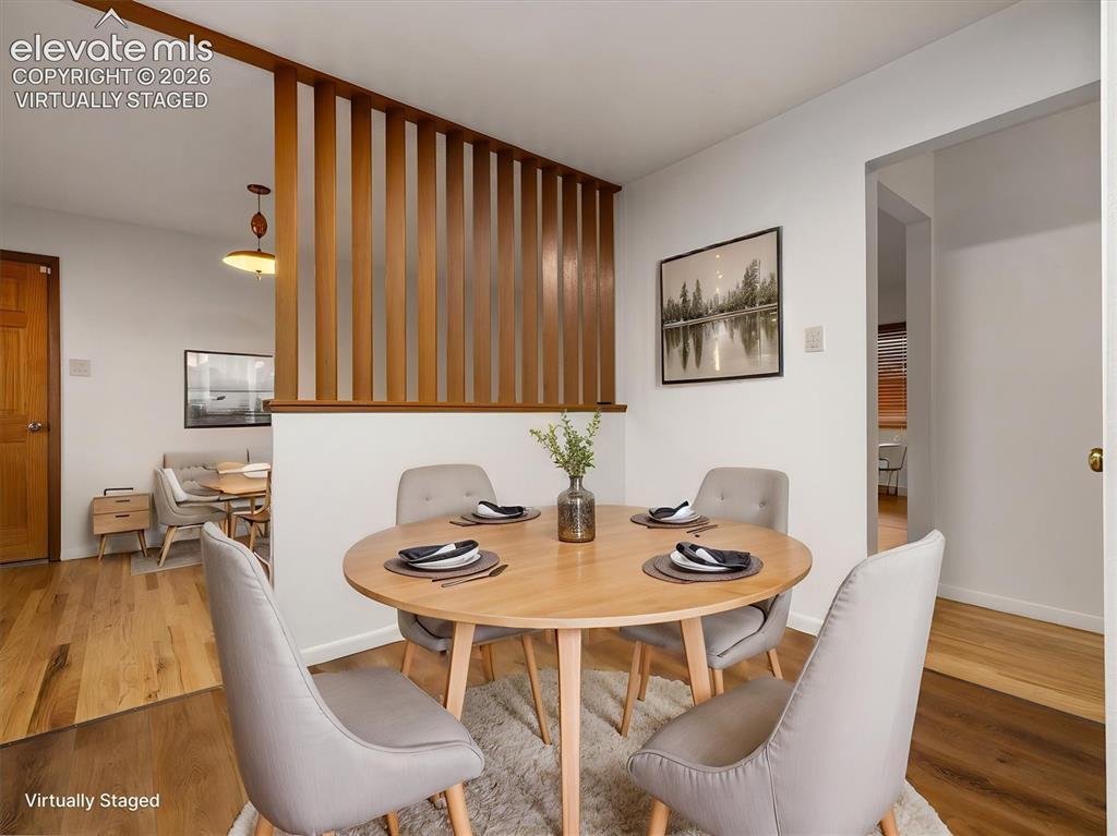 Image 8 of 34: Virtually staged, Wood-finish flooring throughout, light wood room divider,