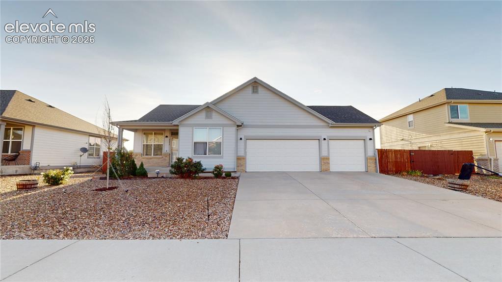 Image 1 of 17: Ranch-style residence featuring light-toned siding, a two-car garage, and a